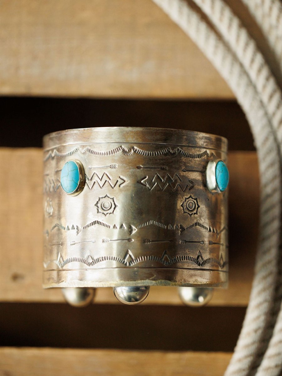 The Sandoval Wine Holder by Savannah Sevens western life{&}style is showcased on a wooden surface beside a coiled rope.