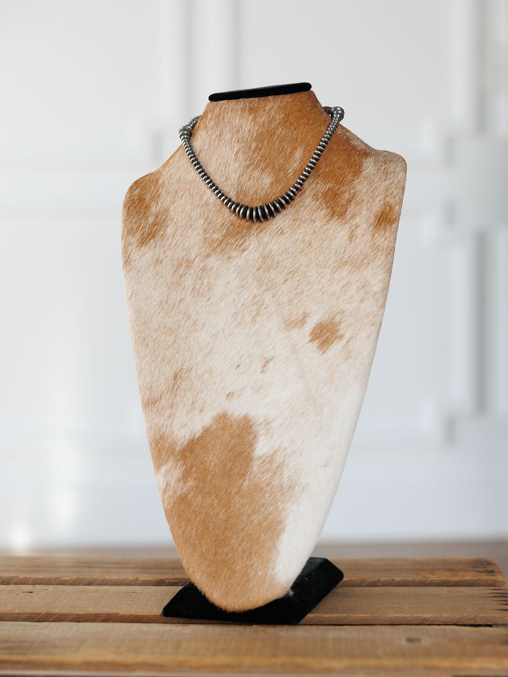 Sarita Graduated Navajo Pearl Necklace in sterling silver displayed on a cowhide-patterned jewelry bust.