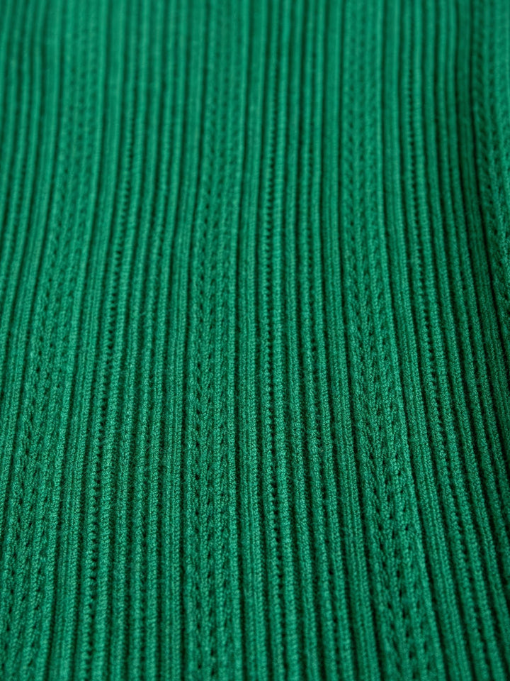 Close-up of the Sebring Emerald Flutter Sleeve Top by Savannah Sevens western life{&}style, highlighting its ribbed knit fabric, vertical textured stripes, and detailed stitching.