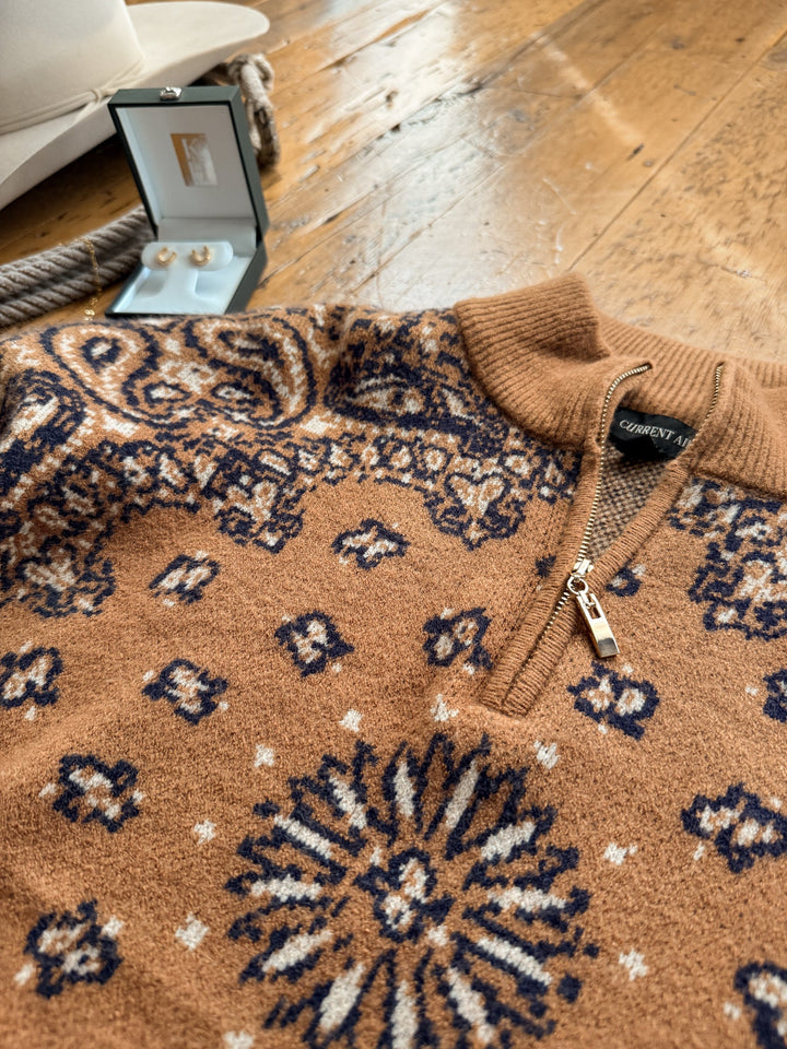 Shiloh Caramel Paisley Quarter Zip Sweater in a caramel-colored woven knit featuring a dark navy and white paisley pattern.