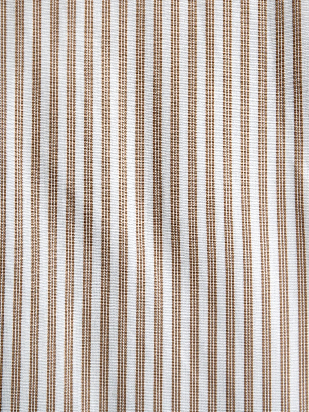 Close-up of the Steger Cinch Men's White Pinstripe Button Up by Savannah Sevens western life{&}style, featuring modern fit cotton with evenly spaced vertical brown and white stripes and a textured, slightly wrinkled finish.
