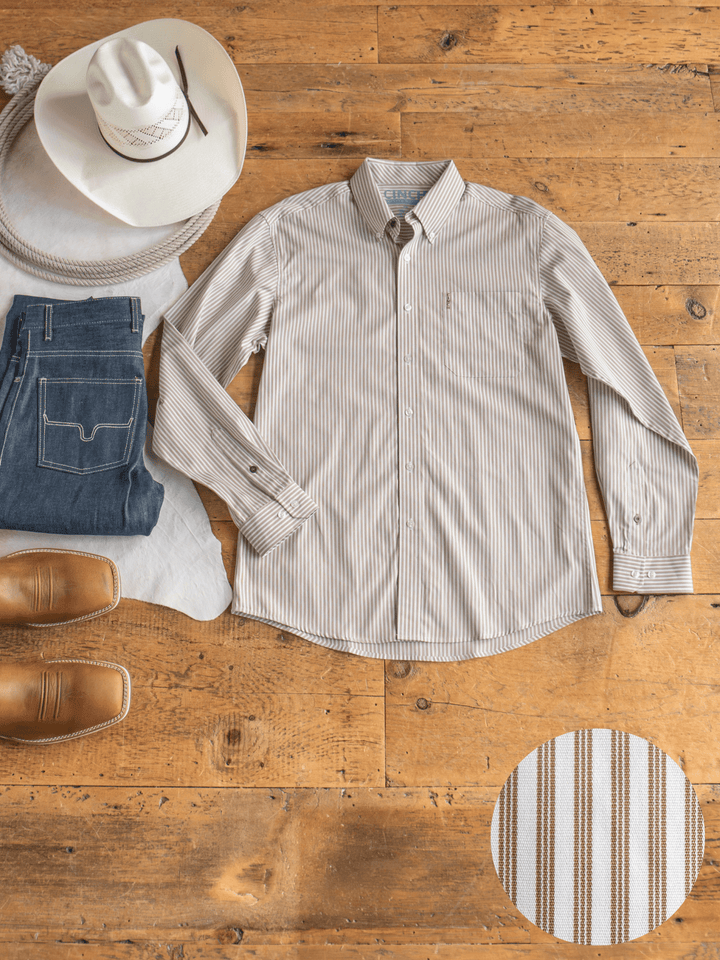 The Steger Cinch Men's White Pinstripe Button Up from Savannah Sevens western life{&}style is displayed on a wooden floor with jeans, a white cowboy hat, coiled rope, and brown boots. An inset showcases the shirt's striped pinstripe fabric.