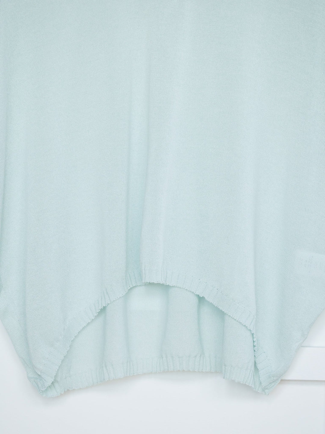 A close-up of the Tallula Light Seafoam Modal Top by Savannah Sevens western life{&}style, featuring a curved, slightly gathered hem and relaxed fit, shown against a white background.