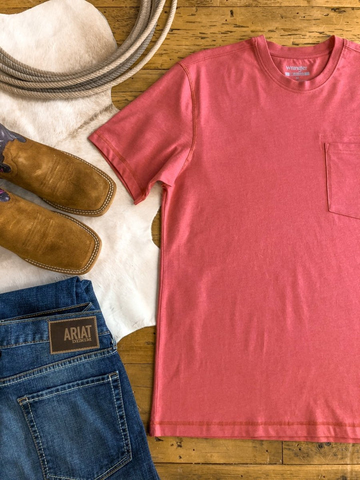 Flat lay featuring The Carver {Men’s} tee (XL) by Savannah Sevens western life{&}style, blue Ariat jeans, tan cowboy boots, a white cowhide, and a coiled rope arranged on a wooden floor.