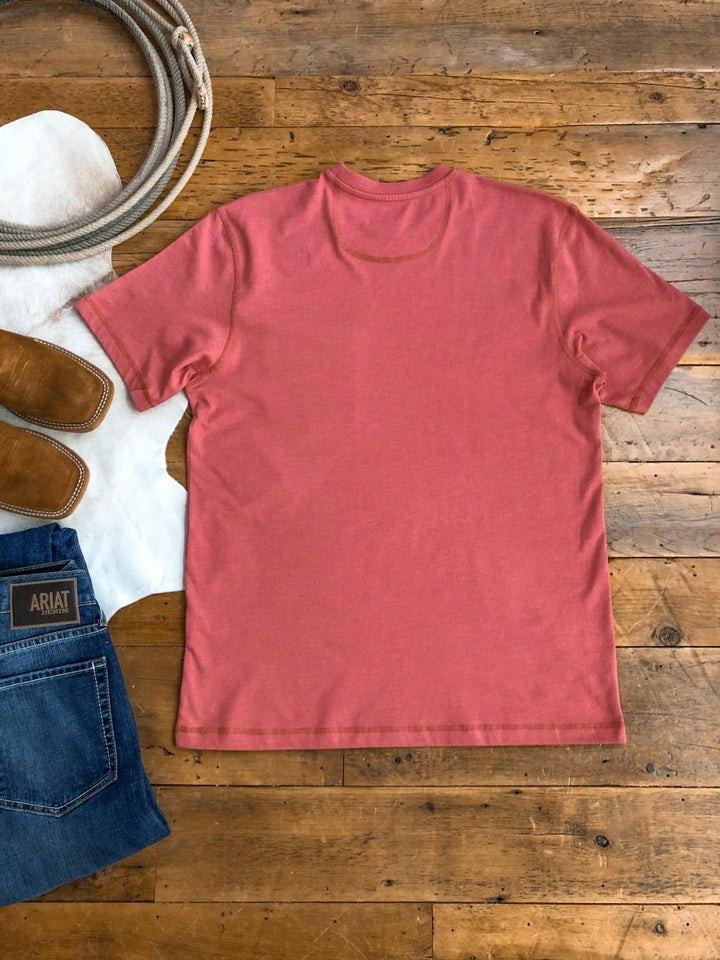 The Carver {Men's} (XL) salmon-colored short sleeve shirt by Savannah Sevens western life{&}style is laid flat with the back facing up on a wooden floor, shown next to jeans, brown cowboy boots, coiled rope, and a white cowhide rug.
