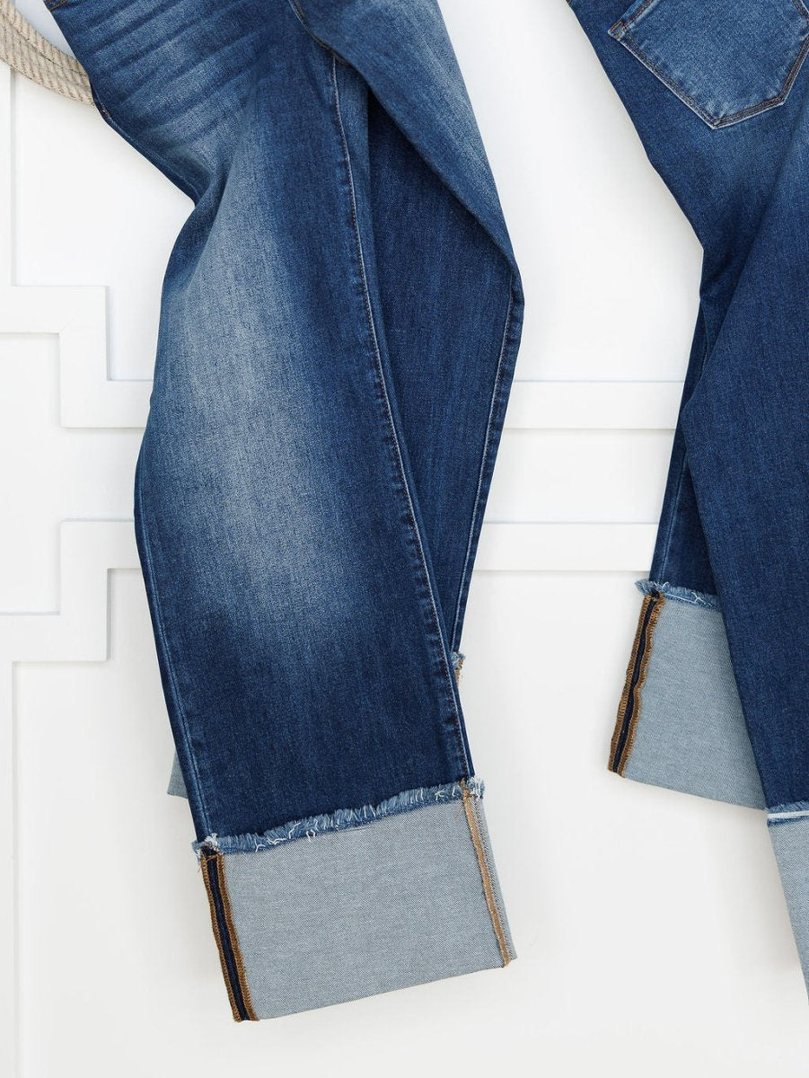 The Knox High Rise Wide Leg Jean by Savannah Sevens western life{&}style features a medium dark wash, wide leg fit, and large wide cuffs that reveal the lighter inside fabric, showcased against a white paneled background.
