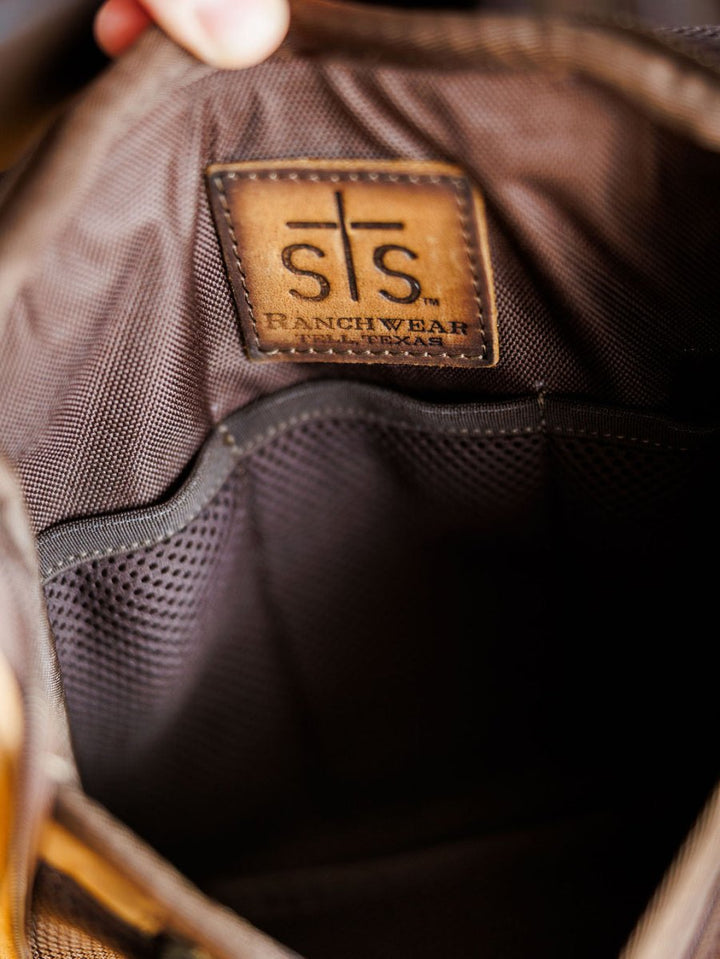 Close-up of The Toledo shave kit by Savannah Sevens western life{&}style, featuring a brown fabric interior, stitched leather patch, and mesh pocket—perfect for organizing essentials in this hanging toiletry bag.