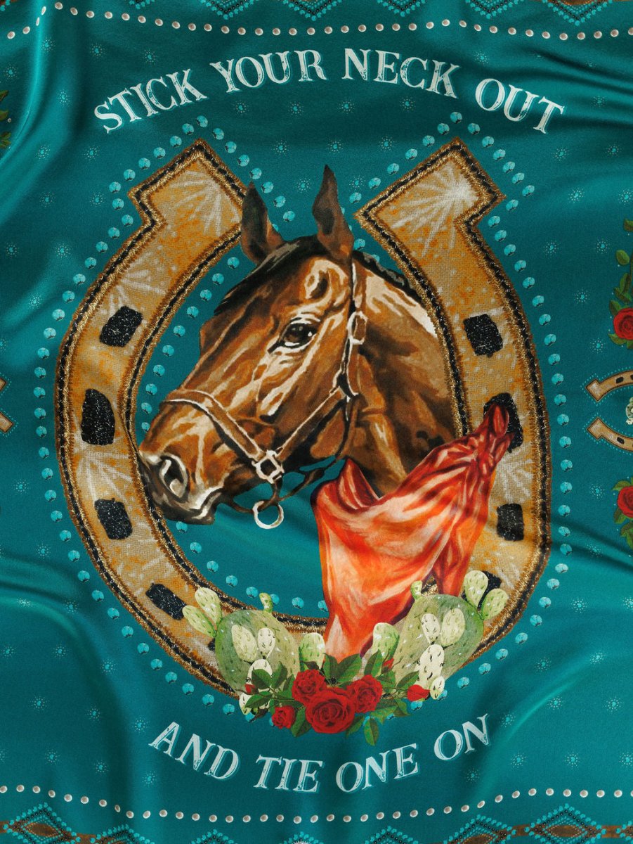 The Tie One On Neck Scarf by Savannah Sevens western life{&}style features a painted western show horse head with a teal scarf, golden horseshoe, cacti, and red roses on teal. “Stick your neck out and tie one on” is displayed in bold text.