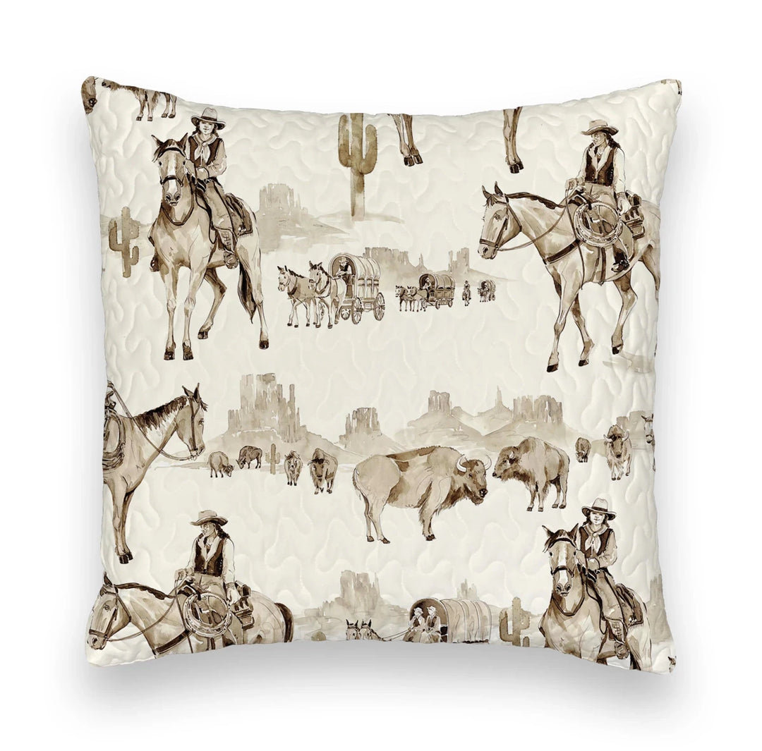 The Vaquera Quilt & Shams by Savannah Sevens western life{&}style features a cream background with sepia western prints—cowboys, bison, cacti, wagons—in 100% cotton and a quilted texture inspired by handmade quilts.