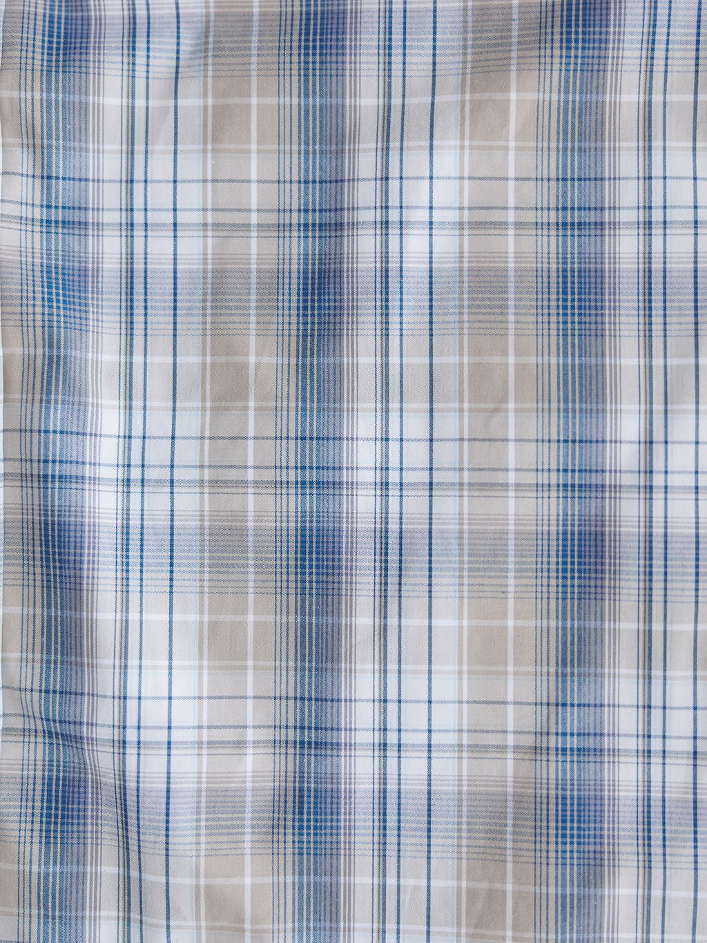 The Wesson Ariat Men's Plaid Button Up by Savannah Sevens western life{&}style features intersecting blue, white, and beige lines in a soft plaid design with moisture-wicking fabric for all-day comfort.