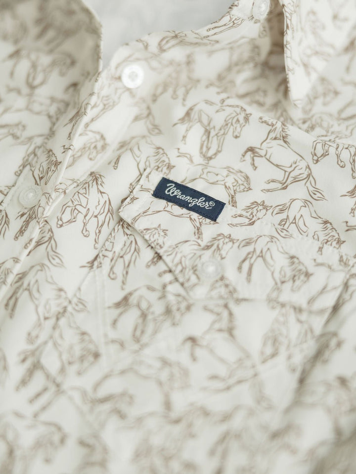 Close-up of the Weston Wrangler Horse Button Top by Savannah Sevens western life{&}style, featuring a brown horse print, small blue Wrangler® tag on the chest pocket, and detailed white buttons.